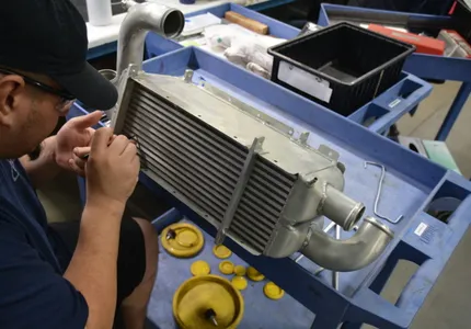 QTC technician inspecting an aircraft heat exchanger