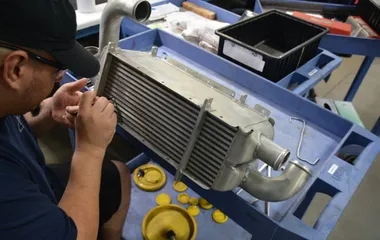 QTC technician inspecting an aircraft heat exchanger