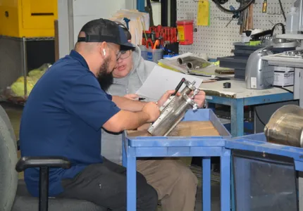 QTC technicians servicing a pneumatic valve assembly