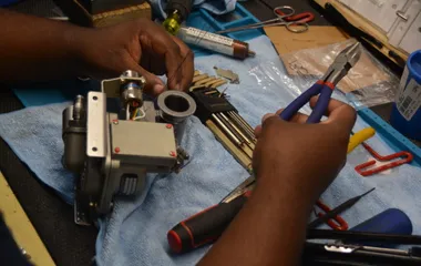 Close-up of precision component repair at QTC