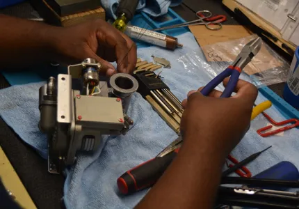 Close-up of precision component repair at QTC