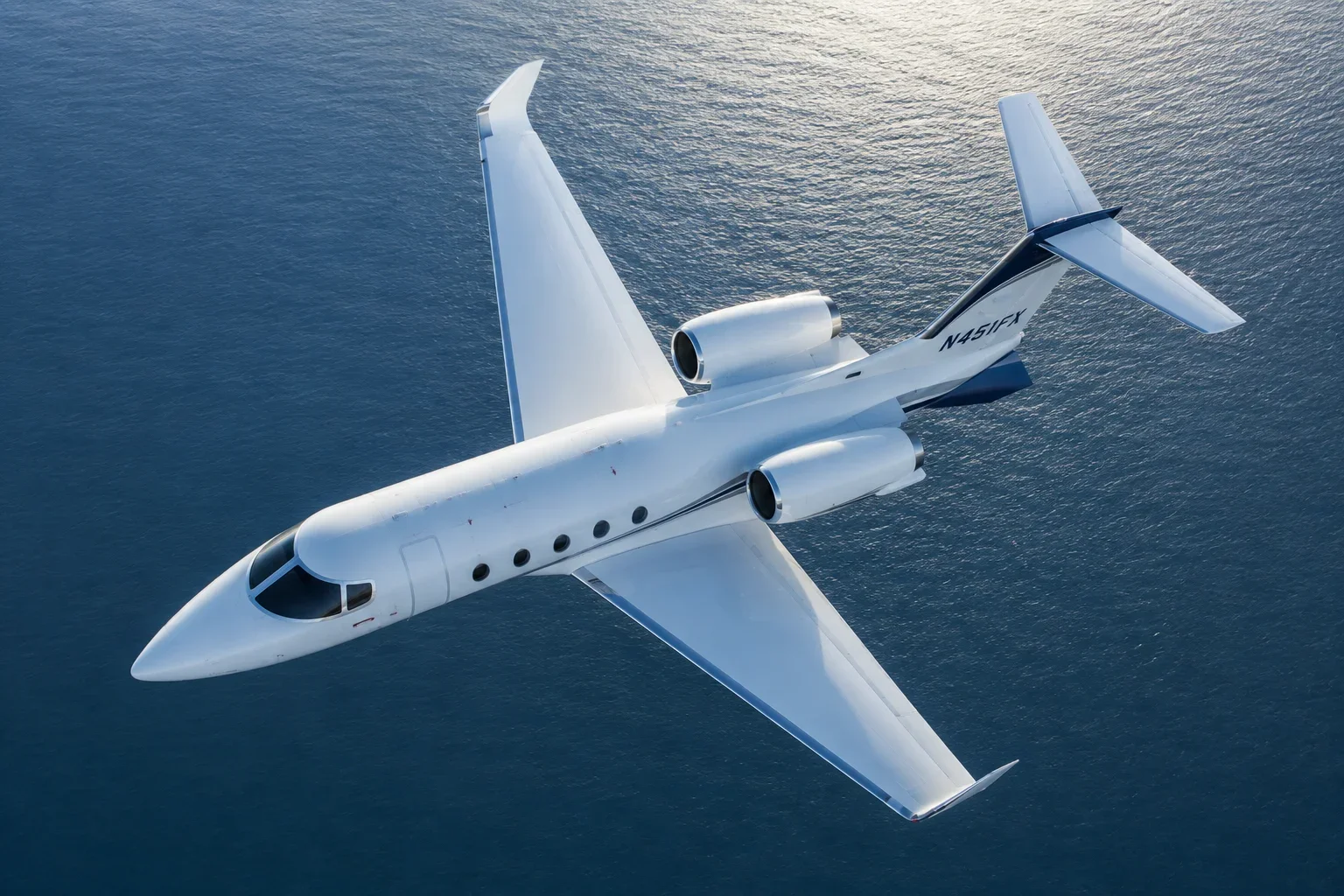 Business jet in flight high over the ocean